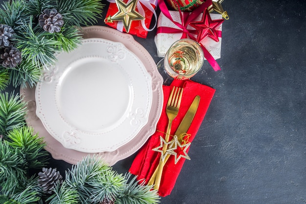 Regolazione della tavola di natale con piatti e bicchiere di champagne