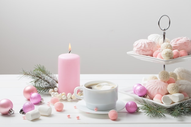 Christmas table with cup of coffee and dessert