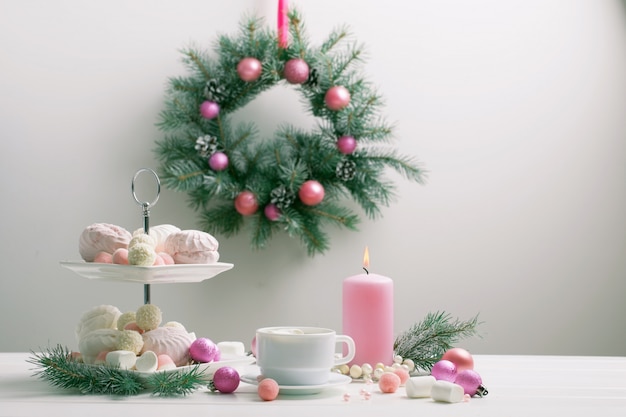 Christmas table with cup of coffee and dessert