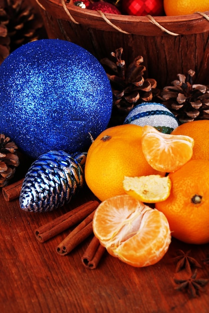 Christmas tangerines and Christmas toys on wooden table close-up