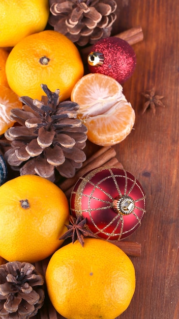 Christmas tangerines and Christmas toys on wooden table close-up