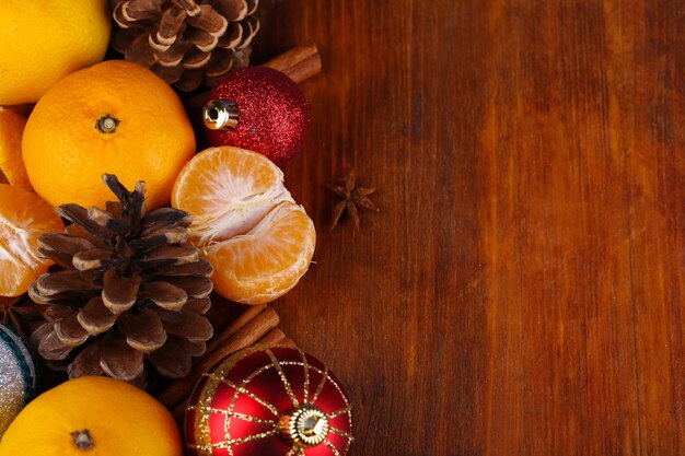 Christmas tangerines and Christmas toys on wooden table close-up