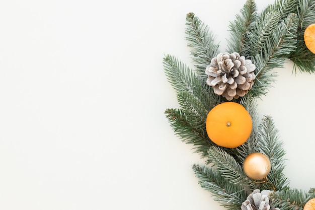 Christmas tangerines with fir and cones on a white background