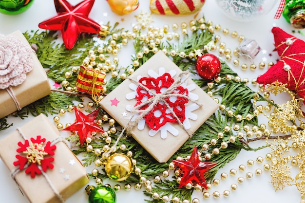 Christmas    thuja branch, decorations and presents wrapped in craft paper  snowflakes.