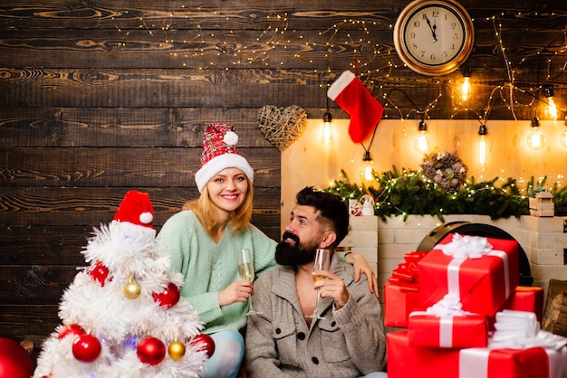 Christmas time Christmas interior Couple in love with Christmas present gift in front of Christmas t