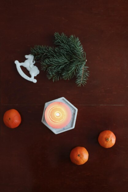 Christmas Toy horse candle tangerines and pine cone Winter holiday items for home decor Flat lay