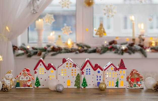 Christmas toy houses on decorated window