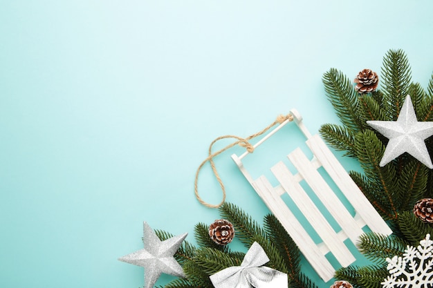 Christmas toy sledge with fir-tree branch on a mint.