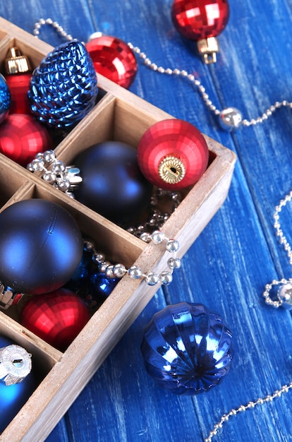 Christmas toys in box on wooden table close-up