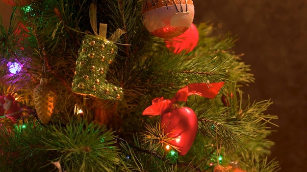 Christmas toys on a Christmas tree closeup a boot and balls