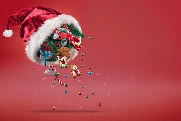 christmas toys fall out of santa hat on red background with copy space christmas content