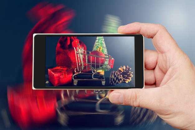 Christmas toys and gifts on the smartphone screen.