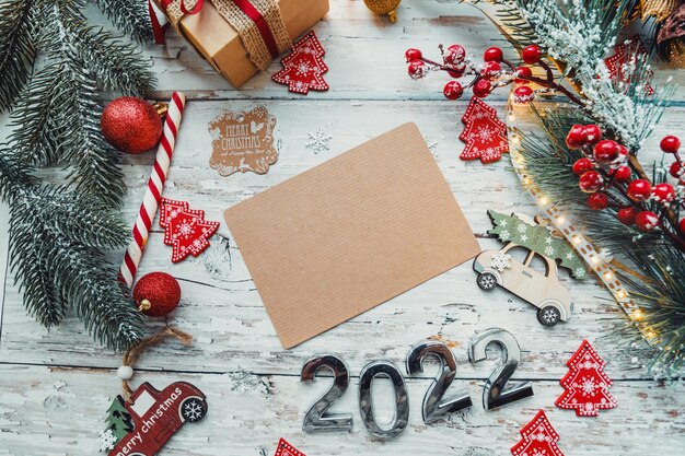 Christmas toys gifts with a craft card for inserting text on a wooden background