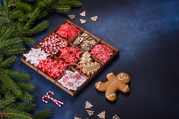 Christmas toys in white and red in a wooden sectional box against a dark concrete background