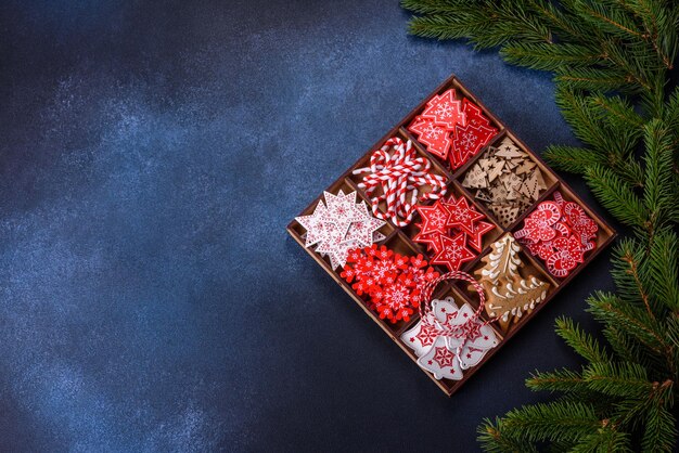 Christmas toys in white and red in a wooden sectional box against a dark concrete background