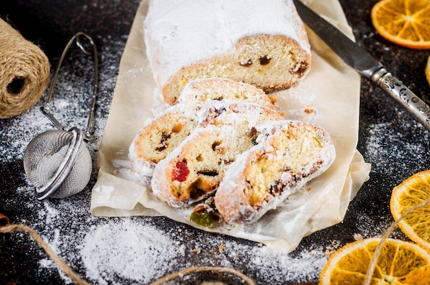 Christmas traditional fruit bread stollen with dried berries nuts and powdered sugar