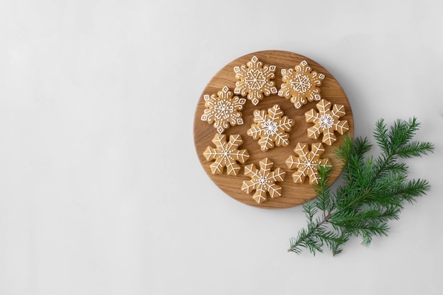 Christmas traditional gingerbread cookies decorated with sugar icing and a fir branch