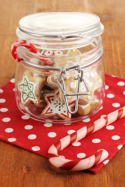 Christmas treats in bank on wooden table close-up