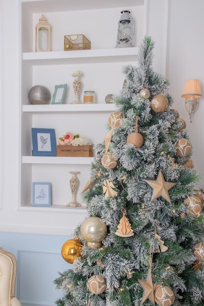 Christmas tree background and Christmas decorations in the modern interior White and gold balls on green fur