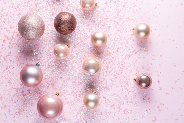 Christmas tree balls on pink  with shiny glitter.