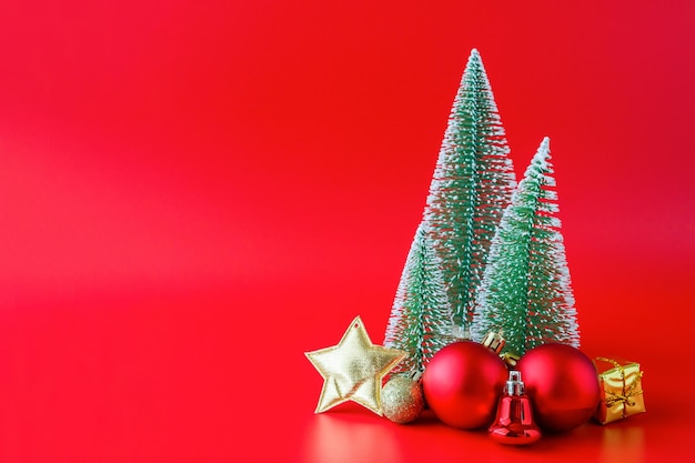 Christmas tree and baubles on red background new year  holiday celebration concept