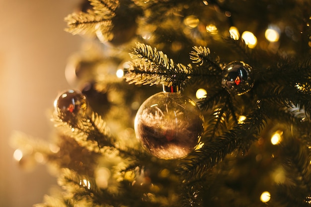 Christmas tree branch with baubles on  blur background festive border New Year magic night