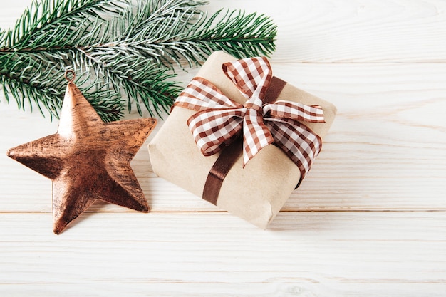 Christmas tree branch with Christmas star and gift box