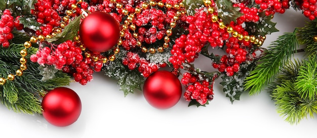 Christmas tree branch with red berries and decorations