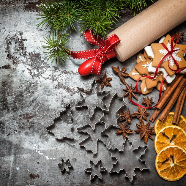 Photo christmas tree branches, cookies and baking ingredients. vintage style toned picture