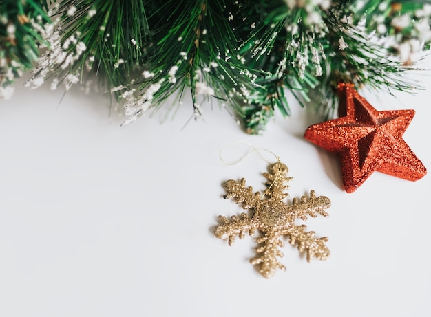 Christmas tree branches decorated with toys red star, snowflake