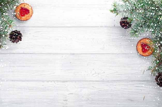 Christmas tree branches on wood background