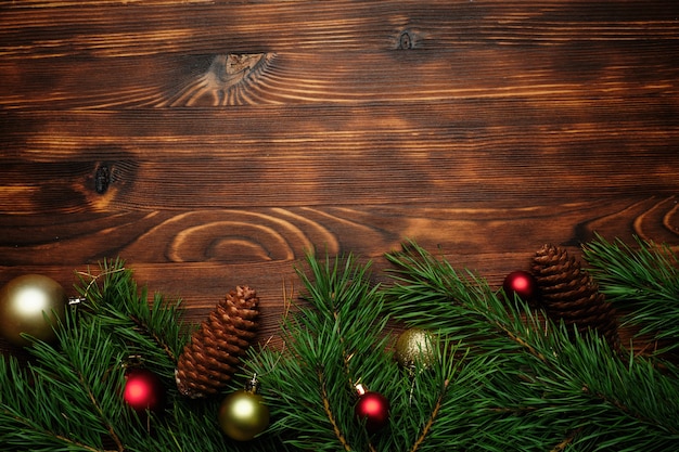 Christmas tree branches on a wooden background