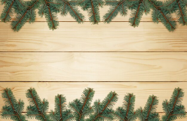 Christmas tree branches on wooden planks