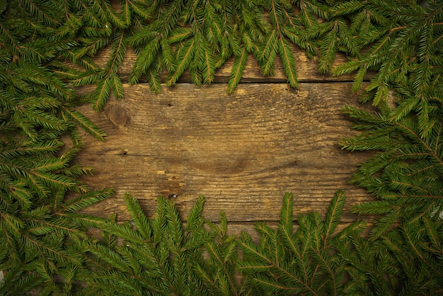 Christmas tree branches on wooden texture