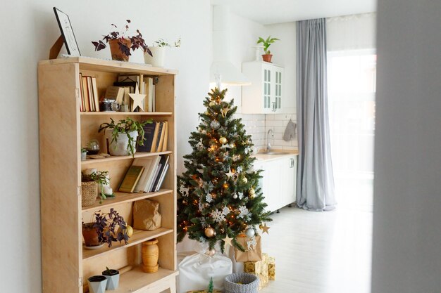 Christmas tree by shelf at home