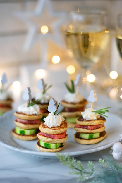 Christmas tree canape with cucumber slice salmon pate and red caviar for festive xmas snack Vertical