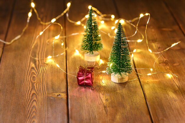 Christmas tree and Christmas present on a wooden table on the background of boke.