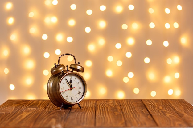 christmas tree clock sledge snowman candles gifts on a wooden background and lights background