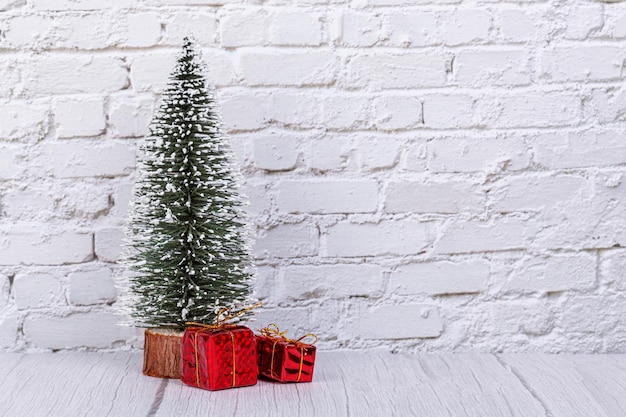 Christmas tree December 31 calendar gifts snowman on the background of a brick wall