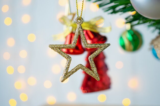 Christmas tree decorated with baubles on pine branches background