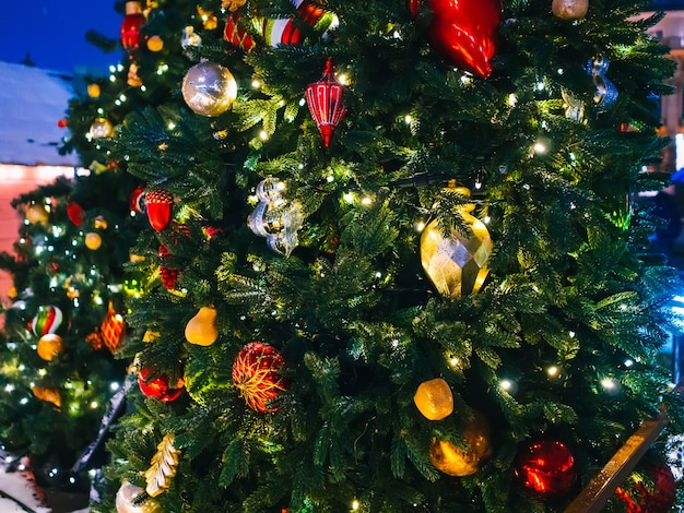 Christmas tree decorated with a garland and Christmas toys