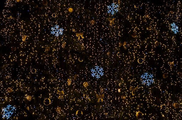 Christmas tree decorated with glowing garlands at night