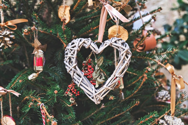 Christmas tree decorated with heartshaped woven wreath and other handmade Christmas zerowaste ornaments