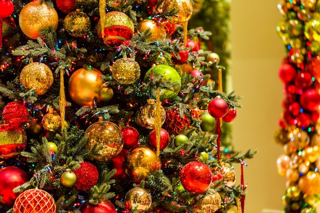 Christmas tree decorated with multicolor ornaments.