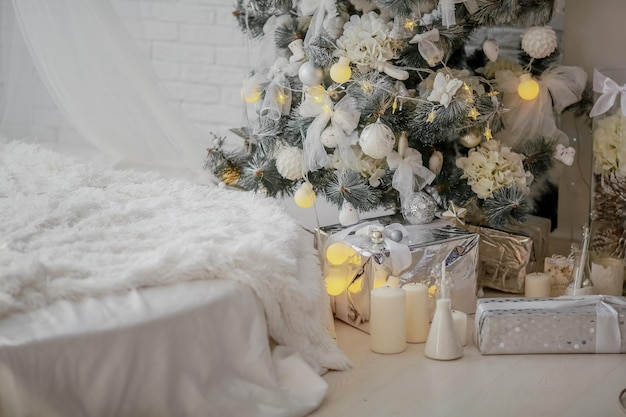 Christmas tree decorated with white toys in a room without people