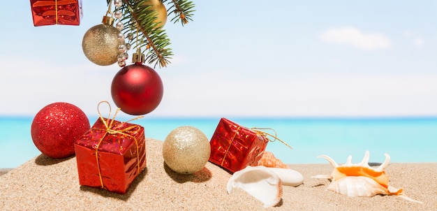 Christmas tree decorations on the beach in tropical sea. Concept of new year holiday in hot countries
