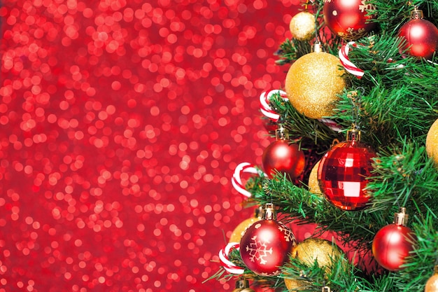 Christmas tree and decorations on red glitter background