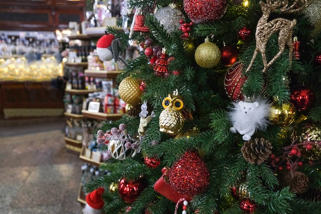 Christmas tree in a festive store before the new year during holiday season. Bokeh.