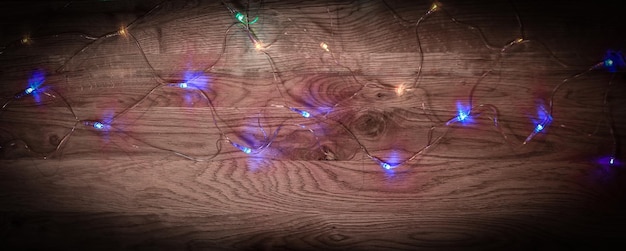 Christmas tree garland laid out on a wooden table