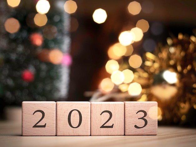 Christmas tree and gift box balls Bokeh garlands in the blur background cube block to contain the purpose of doing business overcoming Developing ideas for the new year 2023x9